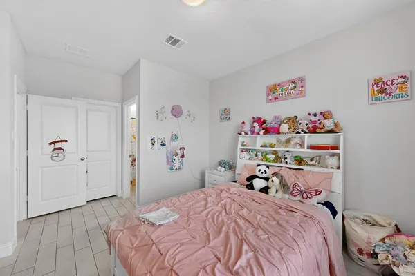 a bedroom with a bed and a closet