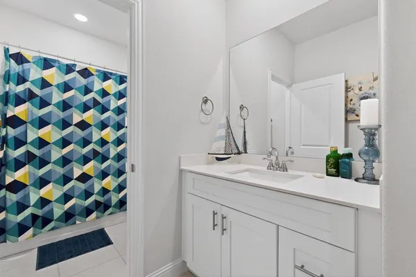 a bathroom with a sink mirror and vanity