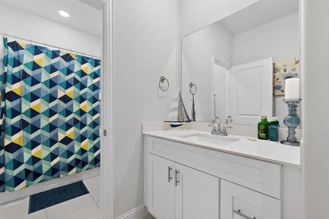 a bathroom with a sink mirror and vanity