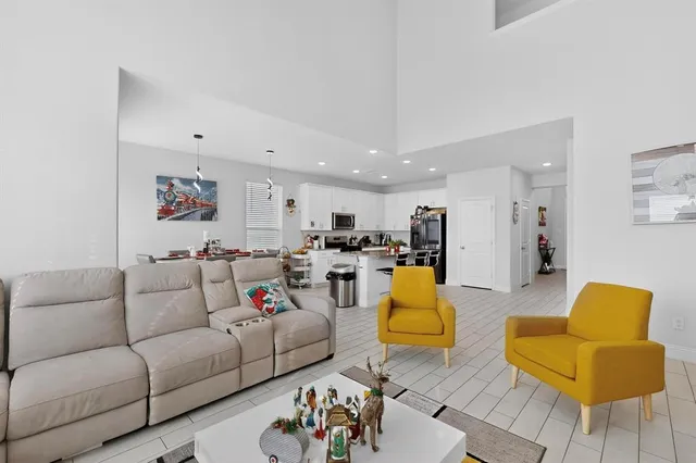 a living room with furniture and kitchen view