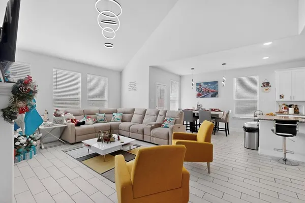 a living room with furniture a rug and a window