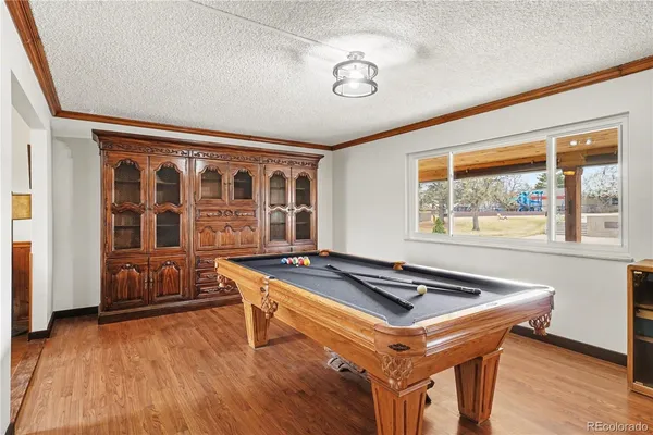 a room with wooden floor and furniture