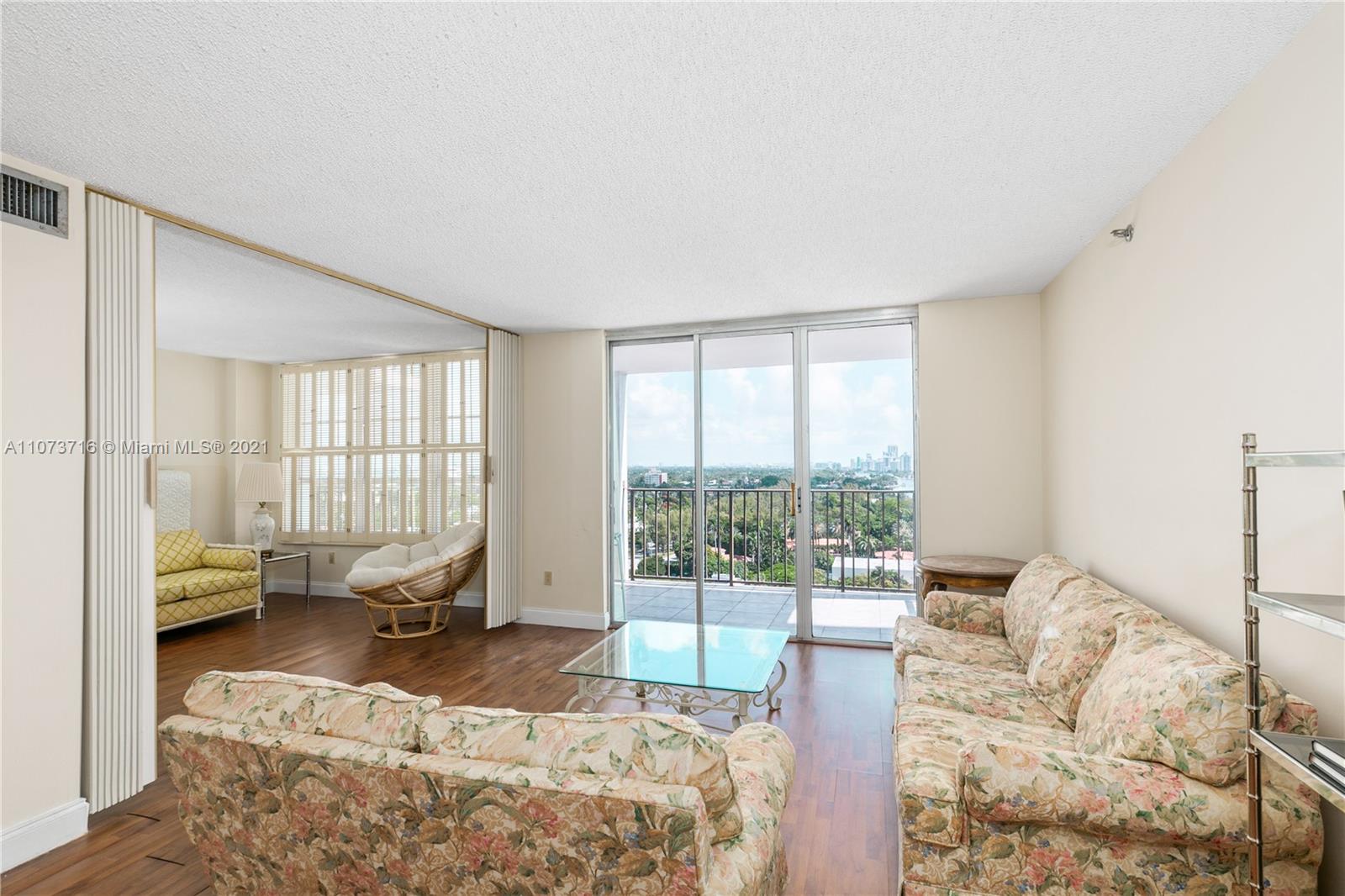 4101 Pine Tree Drive, Unit 1410 Miami Beach, FL 33140 - Photo 4 of 28 a bedroom with a bed and glass window