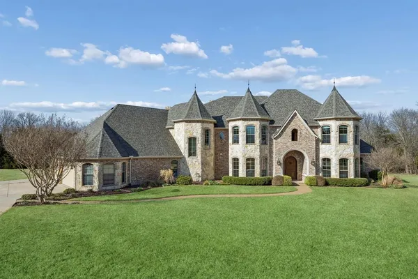 a front view of house with yard and green space