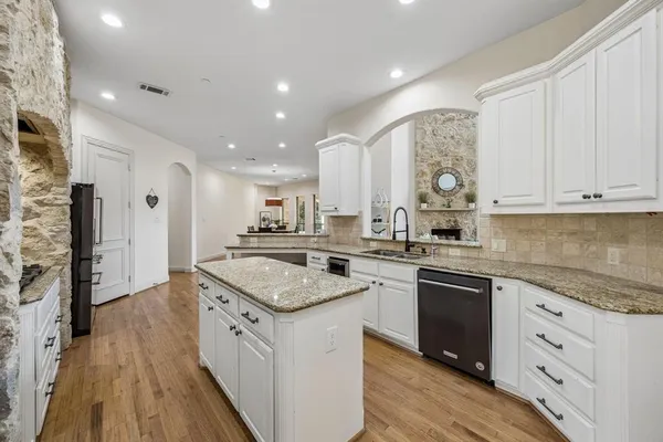 a kitchen with a sink stove and cabinets