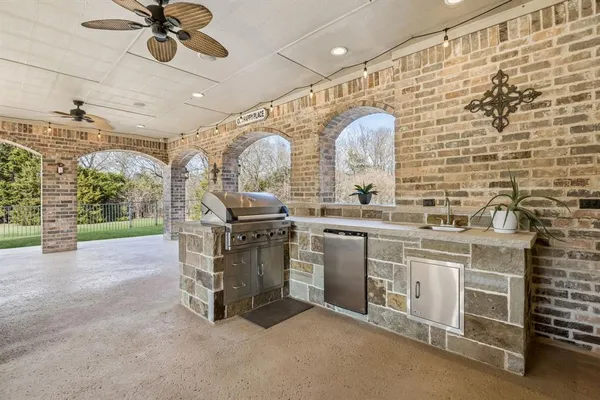 a kitchen with stainless steel appliances kitchen island granite countertop a sink and cabinets