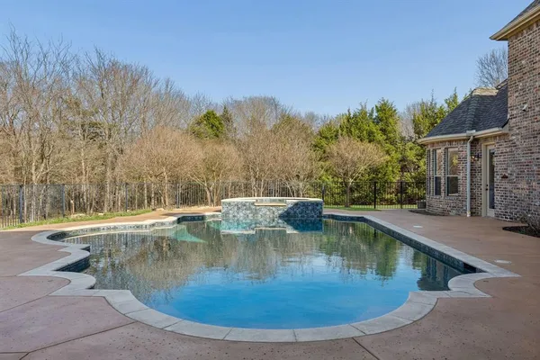 a view of a swimming pool with a yard