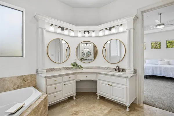 a bathroom with a double vanity sink and a mirror