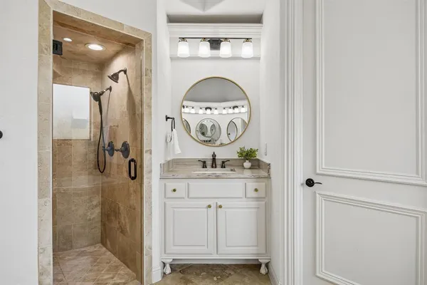 a bathroom with a sink a mirror and shower