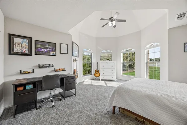 a bedroom with a large bed and a chandelier