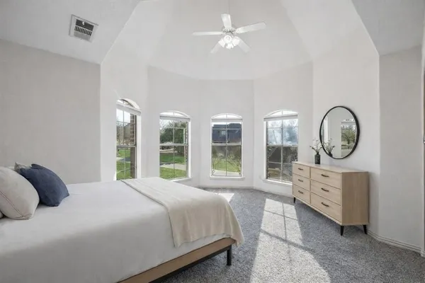 a bedroom with a large bed and a large window