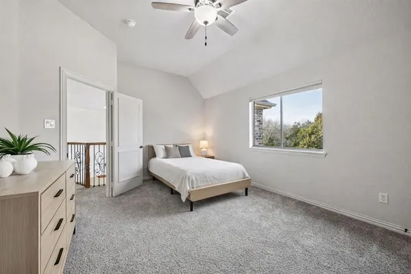 a spacious bedroom with a bed and a window