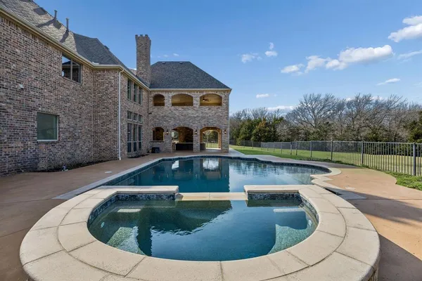 a view of roof deck with a garden and fire pit