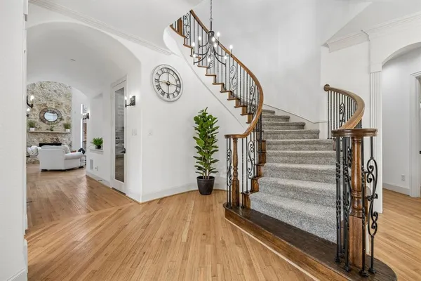 a view of entryway and hall with wooden floor