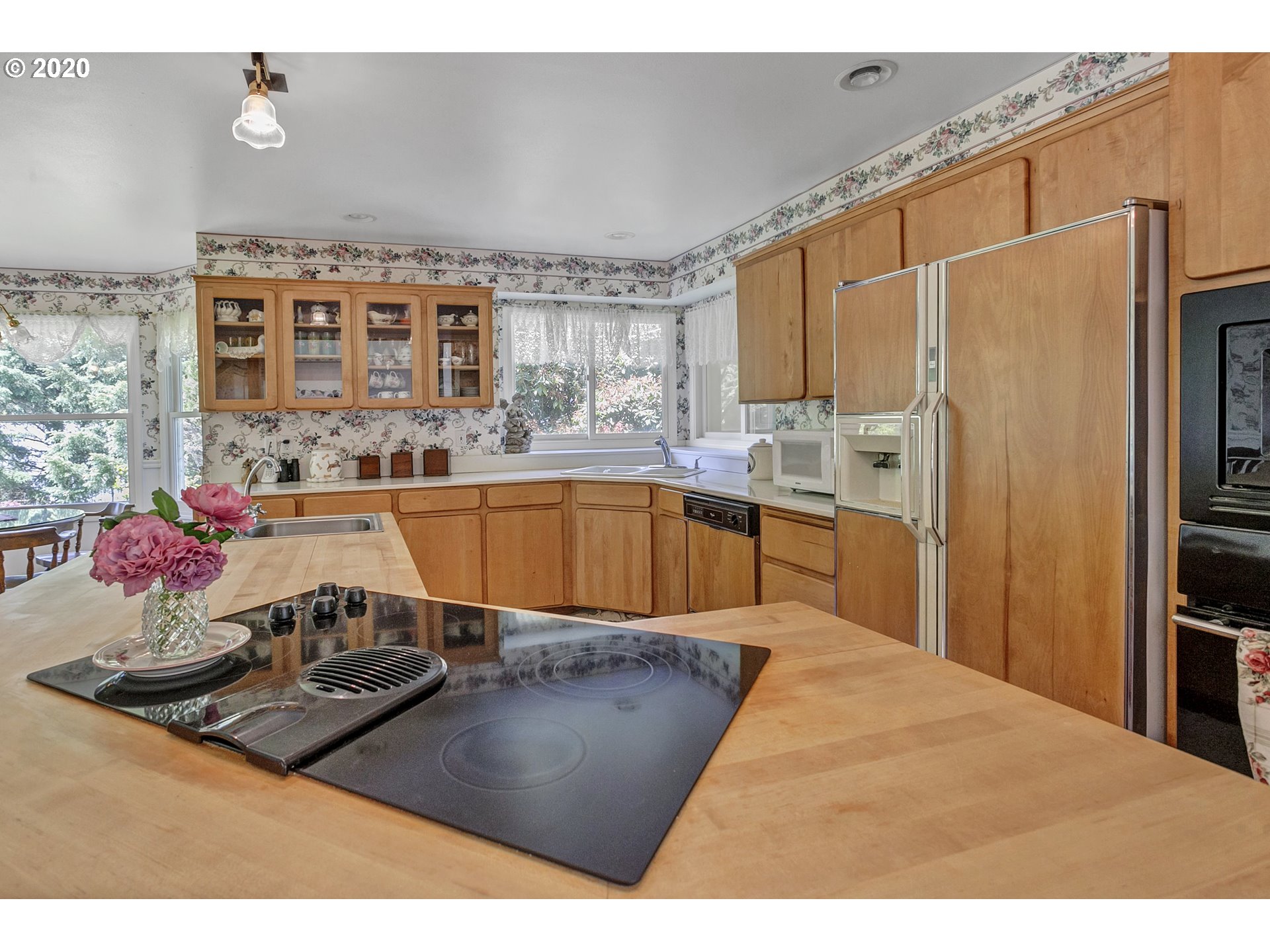 8888 Southeast Rodlun Road Damascus, OR 97089 - Photo 13 of 29 a kitchen with stainless steel appliances granite countertop a stove refrigerator and cabinets