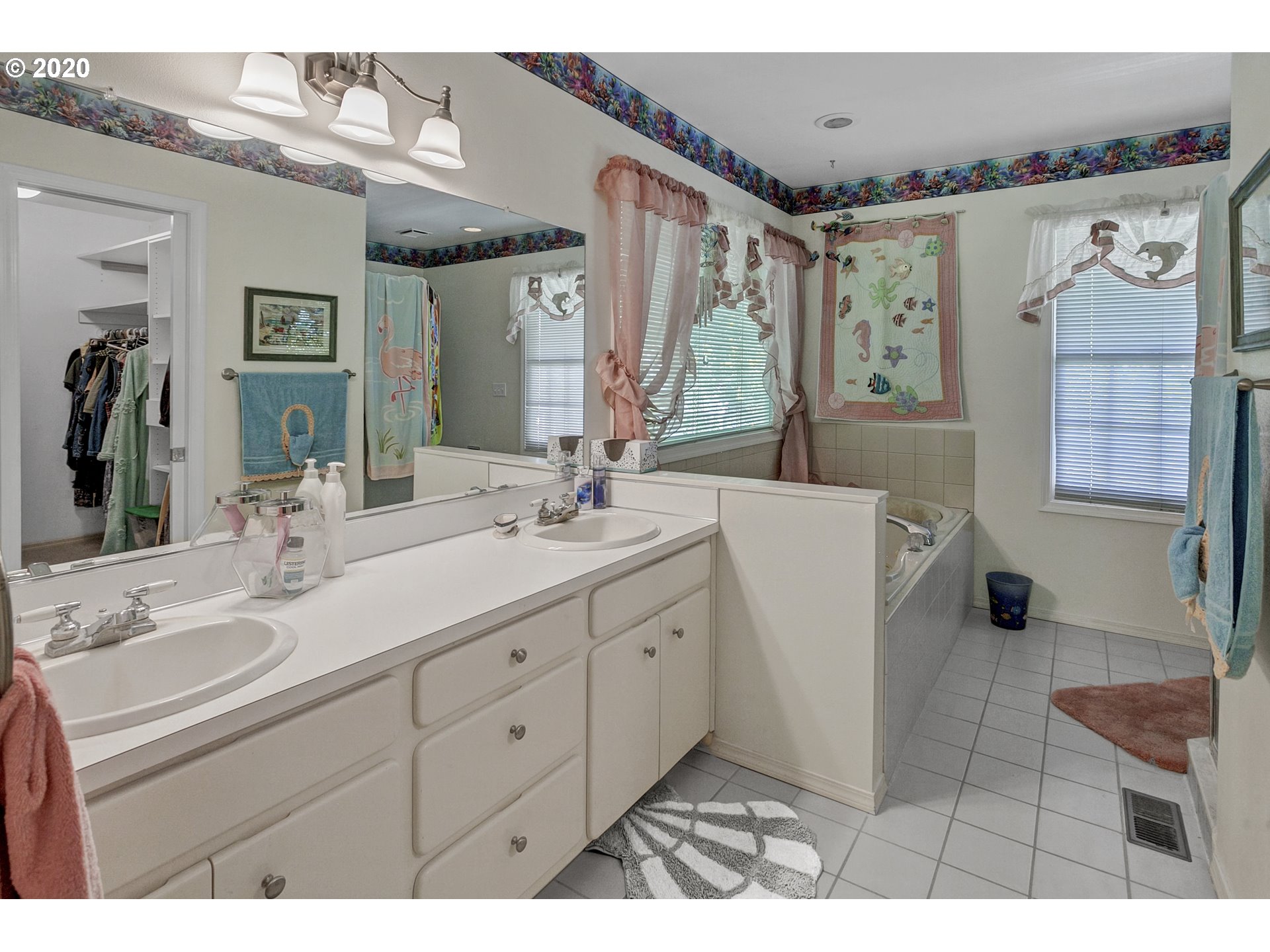 8888 Southeast Rodlun Road Damascus, OR 97089 - Photo 17 of 29 a bathroom with a double vanity sink mirror and bathtub