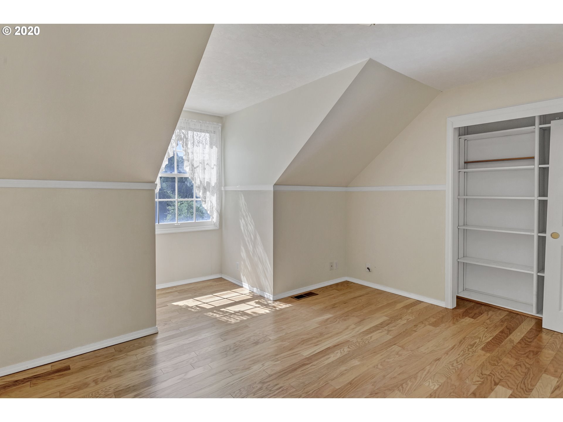 8888 Southeast Rodlun Road Damascus, OR 97089 - Photo 19 of 29 an empty room with wooden floor cabinet and windows