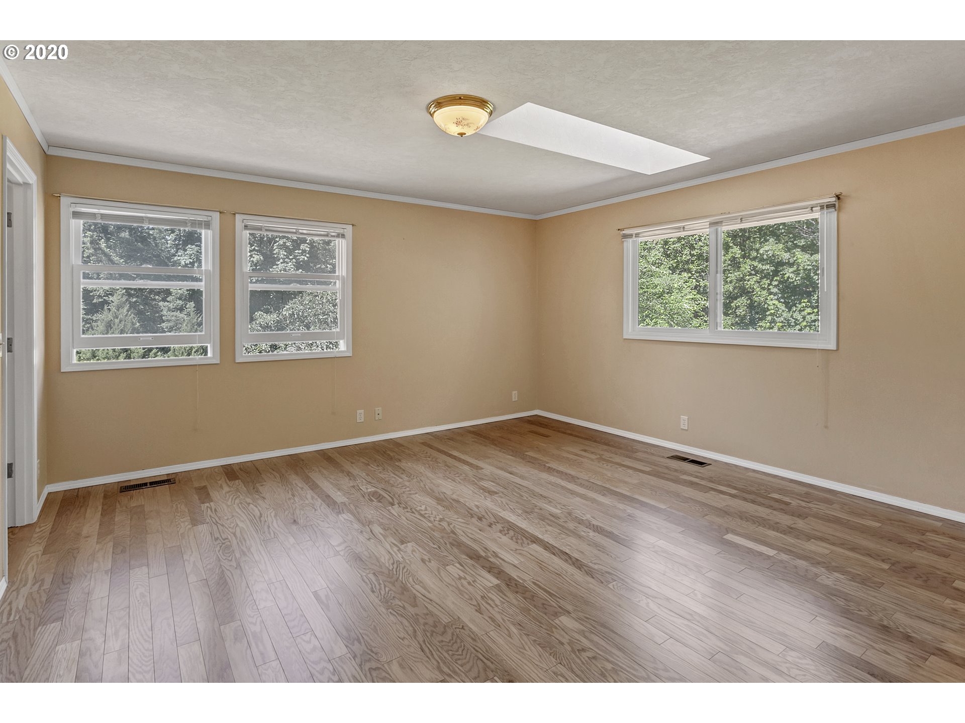 8888 Southeast Rodlun Road Damascus, OR 97089 - Photo 20 of 29 a view of an empty room with wooden floor and a window