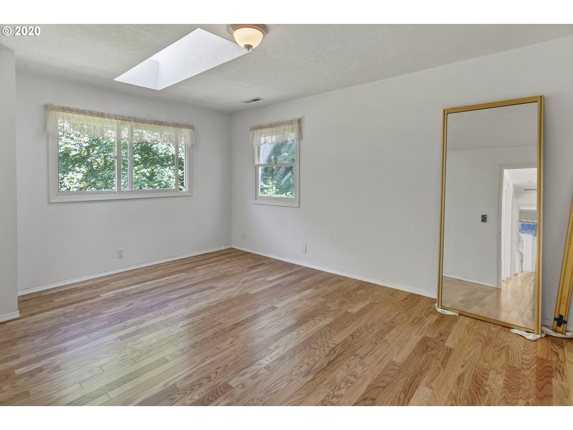 8888 Southeast Rodlun Road Damascus, OR 97089 - Photo 21 of 29 an empty room with wooden floor and windows