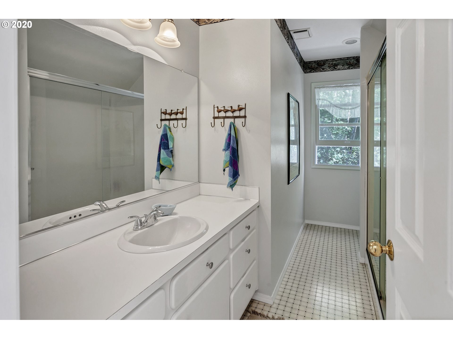 8888 Southeast Rodlun Road Damascus, OR 97089 - Photo 23 of 29 a bathroom with a sink a mirror and a shower