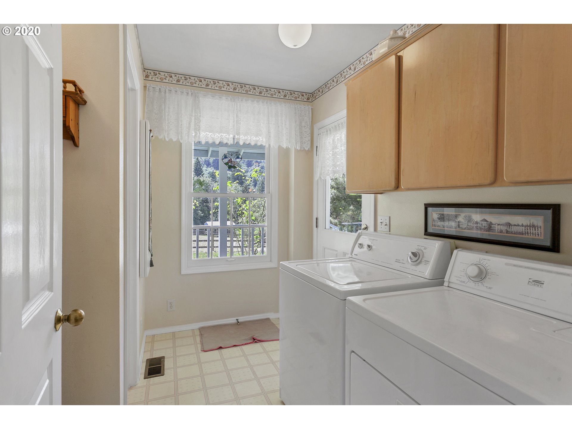 8888 Southeast Rodlun Road Damascus, OR 97089 - Photo 25 of 29 a kitchen with a sink cabinets and a window