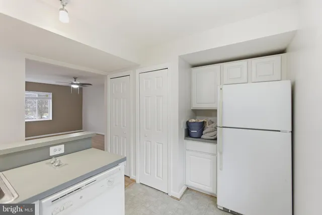 a white refrigerator freezer sitting inside of a kitchen