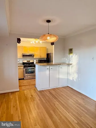 a kitchen with a stove a sink and a refrigerator