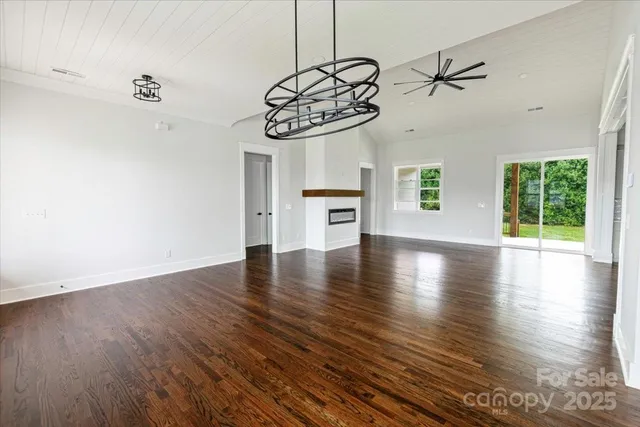 a view of a room with a wooden floor and window