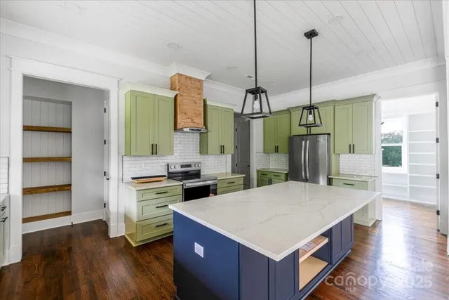 a kitchen with a appliances and a wooden floor