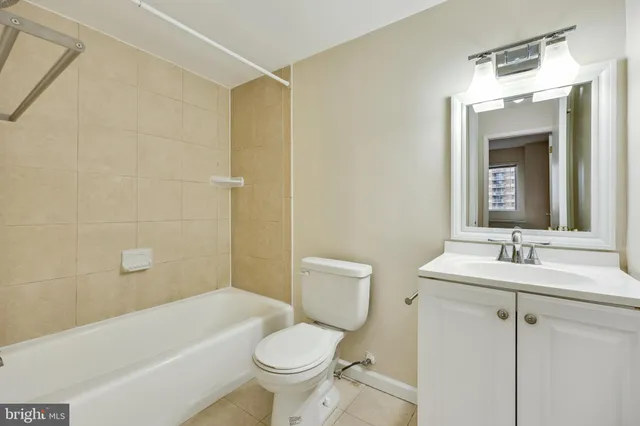 a kitchen with a sink a refrigerator and cabinets