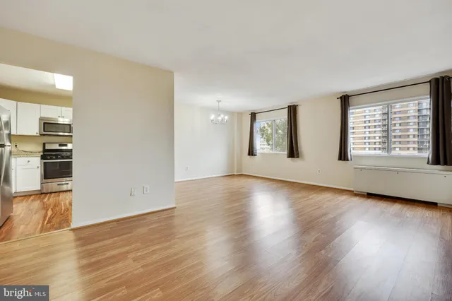 a view of an empty room with wooden floor