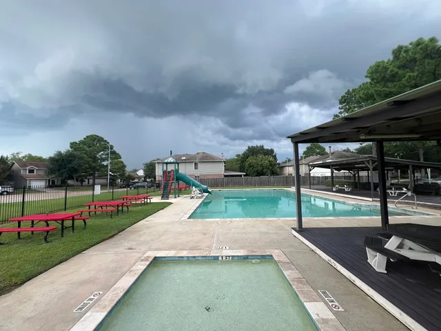 a view of swimming pool with a yard and sitting area