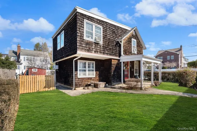 a front view of a house with a yard table and chairs