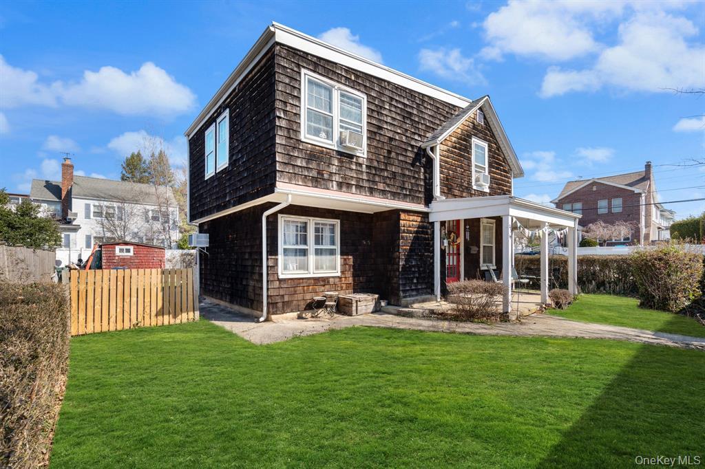 a front view of a house with a yard table and chairs