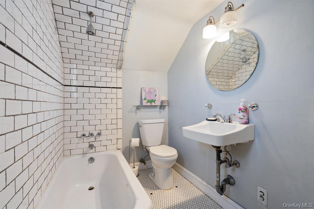 217-19 39th Avenue Queens, NY 11361 - Photo 13 of 38 a bathroom with a sink a toilet and a mirror