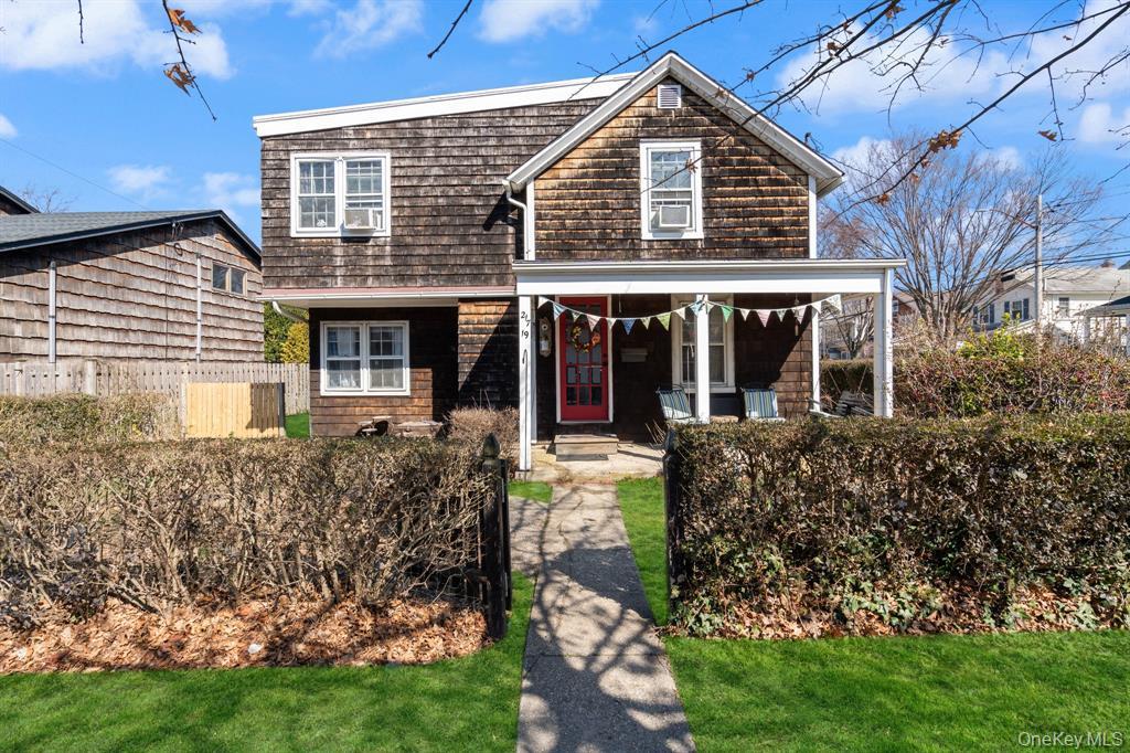 217-19 39th Avenue Queens, NY 11361 - Photo 2 of 38 front view of a house with a yard