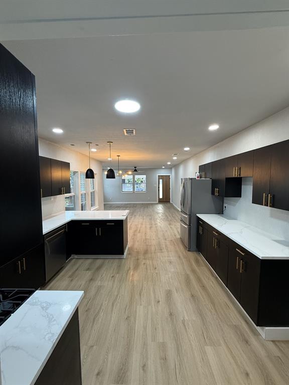 758 Bethpage Avenue Dallas, TX 75217 - Photo 6 of 20 a large kitchen with stainless steel appliances a large counter top a stove and a wooden floors