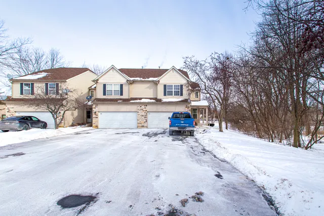 a view of a house with a snow in the yard