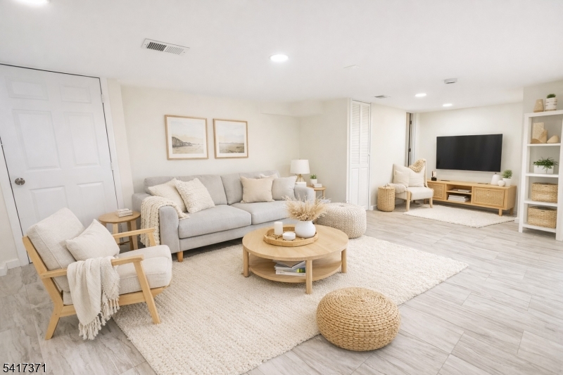 88 Devon Street Kearny, NJ 07032 - Photo 11 of 16 a living room with furniture and a flat screen tv