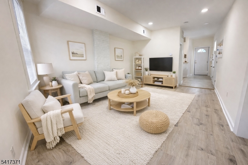 88 Devon Street Kearny, NJ 07032 - Photo 4 of 16 a living room with furniture and a flat screen tv