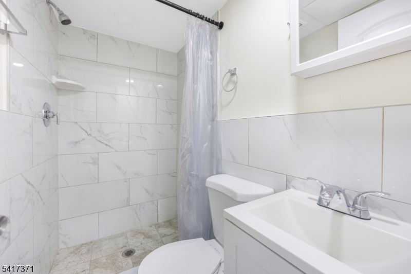 88 Devon Street Kearny, NJ 07032 - Photo 8 of 16 a bathroom with a sink a toilet and shower