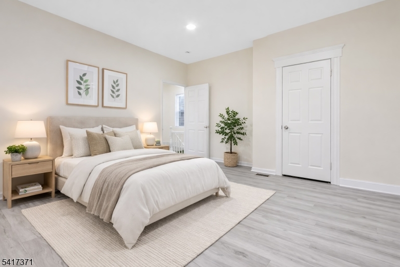 88 Devon Street Kearny, NJ 07032 - Photo 9 of 16 a bedroom with a large bed and paintings on the wall