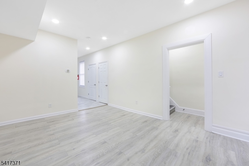 88 Devon Street Kearny, NJ 07032 - Photo 10 of 16 an empty room with wooden floor