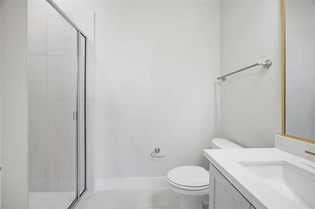 a white toilet sitting next to a bathroom sink