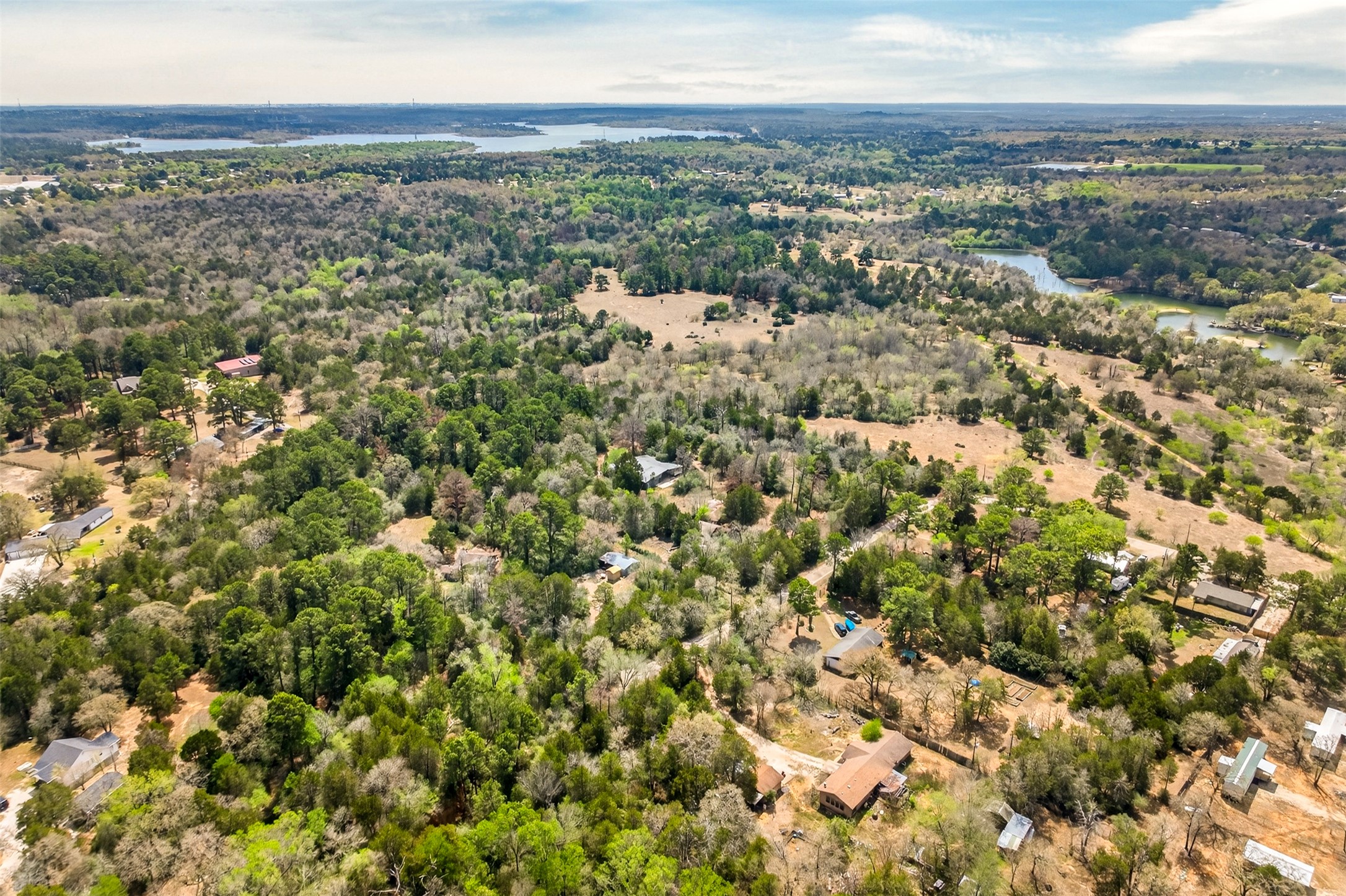 137 Ranchette Street Bastrop, TX 78602 - Photo 4 of 26 Aerial view of a nearby body of water and a heavily wooded area