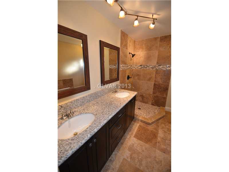 3347 Warnock Road Las Vegas, NV 89102 - Photo 7 of 21 Master Bath/Spa. Master bath features travertine flooring and walk-in shower; dual sink vanity with granite countertops, jacuzzi tub and dual flush toilet