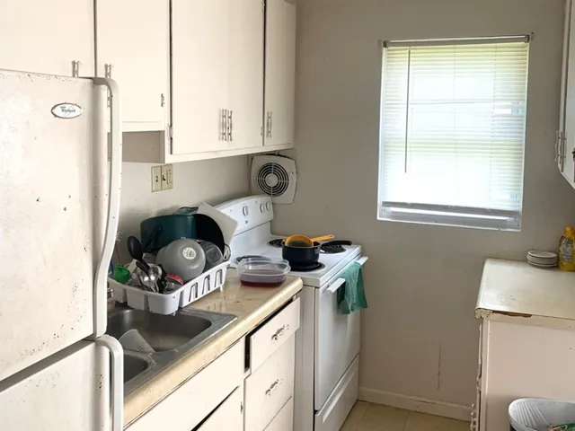 a kitchen with a refrigerator and a stove