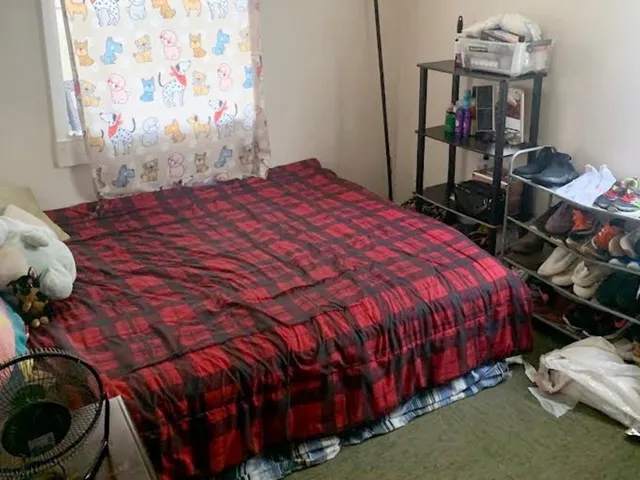 a bed sitting in a bedroom next to a window