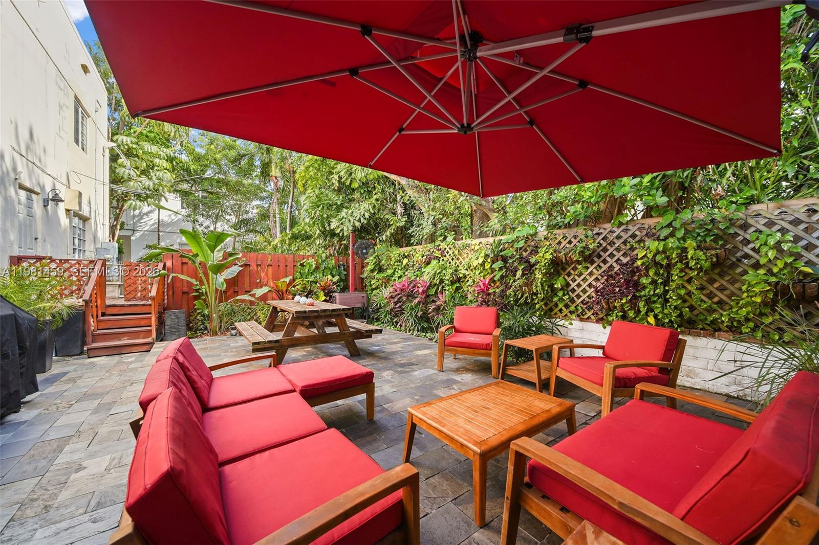 832 15th Street, Unit 4 Miami Beach, FL 33139 - Photo 2 of 17 a outdoor sitting area with furniture and umbrella