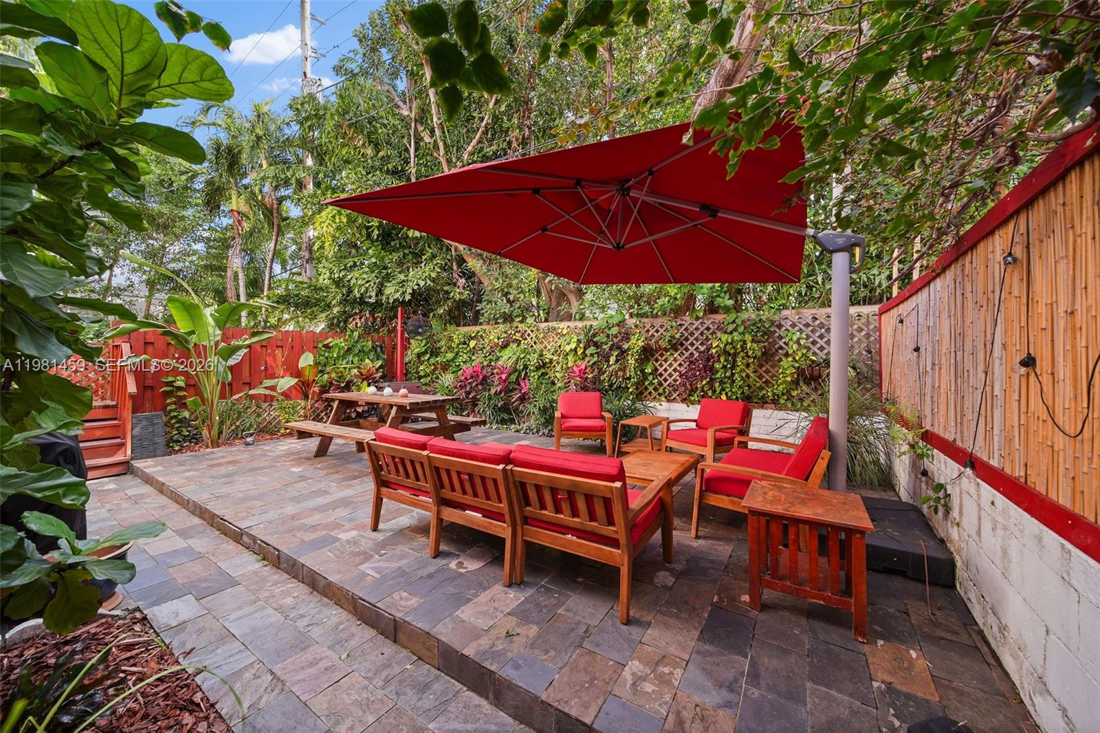 832 15th Street, Unit 4 Miami Beach, FL 33139 - Photo 3 of 17 an outdoor sitting area with umbrella and umbrella
